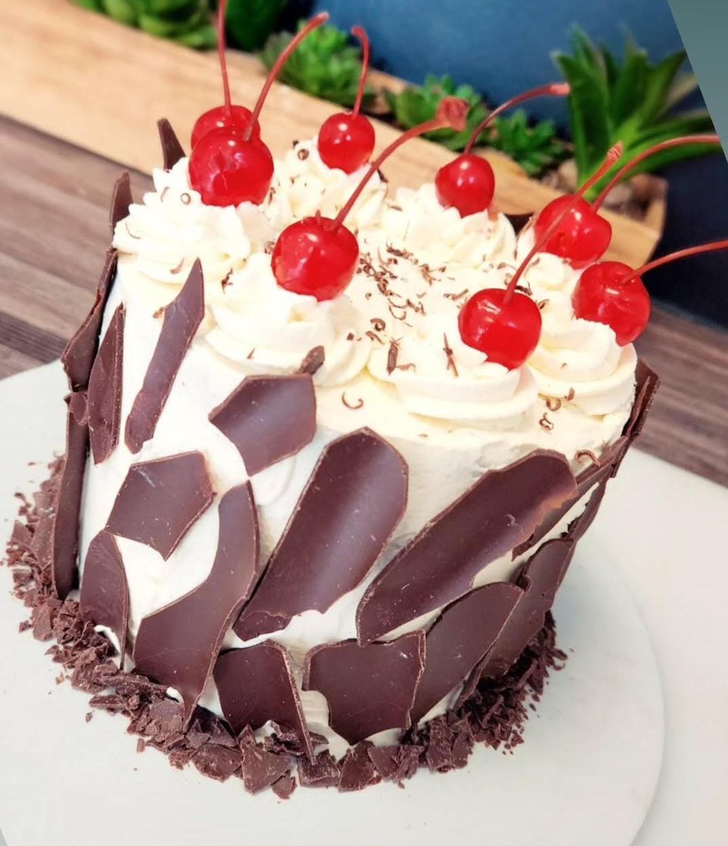 Double chocolate cake with cream and cherries