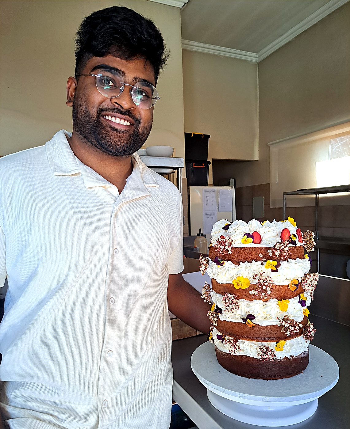 Danté standing next to the finished wedding cake